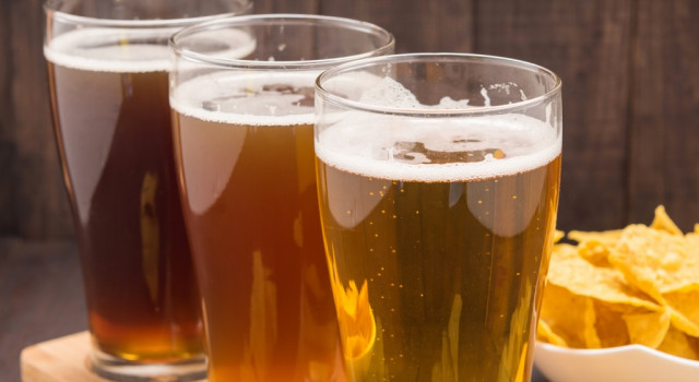 Three Mexican-style lagers with chips in background