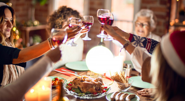 Group of women toasting over roast turkey